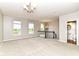 Spacious living area with large windows, neutral walls, staircase, and bathroom access at 174 Straughn Ln, Westfield, IN 46074