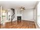 Living room features a cozy fireplace, hardwood flooring, and staircase at 174 Straughn Ln, Westfield, IN 46074