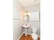 Cozy half-bathroom features pedestal sink and toilet, for easy access on the main floor at 174 Straughn Ln, Westfield, IN 46074
