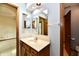 Bathroom vanity featuring a sink, faucet, mirror, and wooden cabinetry at 1783 Cloister Dr, Indianapolis, IN 46260