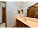 Bathroom vanity featuring a sink, faucet, mirror, and wooden cabinetry at 1783 Cloister Dr, Indianapolis, IN 46260