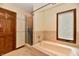 Bright bathroom featuring a bathtub, glass-enclosed shower, and tile flooring at 1783 Cloister Dr, Indianapolis, IN 46260