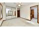 Spacious bedroom featuring a ceiling fan, mirror sliding doors, and natural light from the windows at 1783 Cloister Dr, Indianapolis, IN 46260