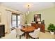 Stylish dining room with modern lighting, a bay window, and a classic wood table at 1783 Cloister Dr, Indianapolis, IN 46260