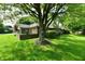 Well-maintained brick home featuring lush green lawn and mature trees at 1783 Cloister Dr, Indianapolis, IN 46260