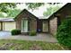 Charming brick home with a bay window and well-manicured landscaping at 1783 Cloister Dr, Indianapolis, IN 46260