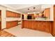 Spacious kitchen featuring wood cabinets, a breakfast bar, and modern appliances at 1783 Cloister Dr, Indianapolis, IN 46260