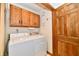 Functional laundry room with a side-by-side washer and dryer, and ample storage space above at 1783 Cloister Dr, Indianapolis, IN 46260