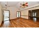 A spacious living room features wood floors, a ceiling fan, and windows offering plenty of natural light at 1783 Cloister Dr, Indianapolis, IN 46260
