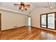 Bright living room with hardwood floors, ceiling fan, and backyard access at 1783 Cloister Dr, Indianapolis, IN 46260