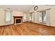 Inviting living room with hardwood floors, fireplace, and ample natural light at 1783 Cloister Dr, Indianapolis, IN 46260