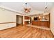 A living room transitions into an open kitchen with wood cabinets and a breakfast bar at 1783 Cloister Dr, Indianapolis, IN 46260