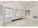 Bright sunroom with tile flooring, multiple windows, and natural light at 1783 Cloister Dr, Indianapolis, IN 46260