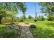 Spacious backyard featuring a stone fire pit and lush greenery, perfect for outdoor gatherings at 1914 S Avon Ave, Avon, IN 46123