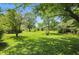 Lush backyard with mature trees providing ample shade and a sprawling lawn at 1914 S Avon Ave, Avon, IN 46123