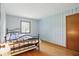 Charming bedroom with hardwood floors, blue wallpaper accent wall and natural light at 1914 S Avon Ave, Avon, IN 46123