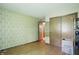 Bedroom with wood floors, muted wallpaper and a double closet for storage at 1914 S Avon Ave, Avon, IN 46123