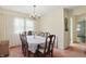Traditional dining room featuring a decorative chandelier and a bright window view with white curtains at 1914 S Avon Ave, Avon, IN 46123