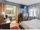 Main bedroom connected to the bathroom, featuring blue walls, a flat screen tv and a large dresser at 1914 S Avon Ave, Avon, IN 46123