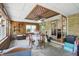 Cozy sunroom with wood paneling, a unique ceiling design, and natural light at 1914 S Avon Ave, Avon, IN 46123