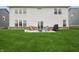 Spacious backyard featuring a patio with fire pit and well-maintained lawn at 19652 Shadow Trace Path, Westfield, IN 46074