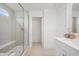 Bright bathroom offers a glass shower, a comfortable seat, tile floors, a quartz countertop, and storage cabinets at 19652 Shadow Trace Path, Westfield, IN 46074
