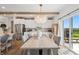 Chic dining area with wood table, seating for six, and sliding glass doors to the outdoor area at 19652 Shadow Trace Path, Westfield, IN 46074