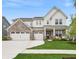 Beautiful two-story home featuring brick and white siding, a three-car garage, and a well-manicured front lawn at 19652 Shadow Trace Path, Westfield, IN 46074