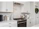 Modern kitchen with white cabinetry, marble backsplash, and stainless steel oven at 19652 Shadow Trace Path, Westfield, IN 46074