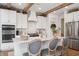 Bright, modern kitchen featuring white cabinetry, marble backsplash, and a spacious island with seating for three at 19652 Shadow Trace Path, Westfield, IN 46074