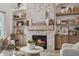 Stone fireplace with a wood mantel and hearth, flanked by arched built-in shelves at 19652 Shadow Trace Path, Westfield, IN 46074