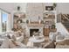 Inviting living room with a stone fireplace, built-in shelves and comfortable seating at 19652 Shadow Trace Path, Westfield, IN 46074