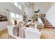 Bright living room with fireplace, built-in shelving, large windows, hardwood floors, and staircase at 19652 Shadow Trace Path, Westfield, IN 46074
