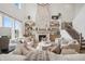 Bright, open living room with stone fireplace, shelving, and large windows at 19652 Shadow Trace Path, Westfield, IN 46074