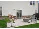 Cozy backyard patio with fire pit, chairs, and lush green grass at 19652 Shadow Trace Path, Westfield, IN 46074