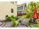Landscaped backyard with lush greenery, patio furniture, and well-maintained brickwork at 2020 N Park Ave, Indianapolis, IN 46202