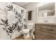 Bright bathroom with a modern vanity, white toilet, and decorative shower curtain at 2020 N Park Ave, Indianapolis, IN 46202
