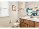Bathroom with a single sink vanity, white toilet, and window for natural light at 2020 N Park Ave, Indianapolis, IN 46202