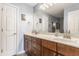 Bright bathroom featuring double sinks, wood cabinets, and a large mirror at 2020 N Park Ave, Indianapolis, IN 46202
