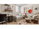 Cozy bedroom with a twin bed, modern art, comfortable chair, and wood-style floors at 2020 N Park Ave, Indianapolis, IN 46202