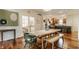 Bright dining area with hardwood floors, light wood table, and view to kitchen at 2020 N Park Ave, Indianapolis, IN 46202