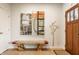 Inviting foyer with a wooden bench, modern art, and an elegant stained glass front door at 2020 N Park Ave, Indianapolis, IN 46202