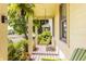 Inviting covered front porch with a hanging swing, planters, and bright yellow siding details at 2020 N Park Ave, Indianapolis, IN 46202