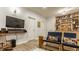 Finished basement with built-in shelves, large-screen television, and unique chairs at 2020 N Park Ave, Indianapolis, IN 46202