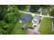 An aerial view of a beautiful home with a dark roof, green grass, and lush green trees at 2159 W 58Th Nw St, Indianapolis, IN 46228
