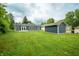 Expansive backyard with lush green grass, a house with new siding and a shed at 2159 W 58Th Nw St, Indianapolis, IN 46228