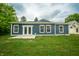 Back of the house with blue siding and white trim, overlooking a green lawn at 2159 W 58Th Nw St, Indianapolis, IN 46228