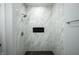 Stunning bathroom featuring a frameless shower with marble tile and dark accents at 2159 W 58Th Nw St, Indianapolis, IN 46228