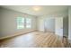 Bright bedroom with natural light, wood flooring, and a spacious closet for comfortable living at 2159 W 58Th Nw St, Indianapolis, IN 46228