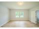 Spacious bedroom featuring two large windows, neutral paint, wood-look floors, and modern lighting at 2159 W 58Th Nw St, Indianapolis, IN 46228